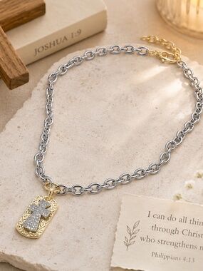 Chunky silver link necklace with a silver and gold cross pendant